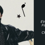 Promotional image of Jin used as the cover for the Bangtan Now blog article about the Jin Tour. Jin appears with arms open, wearing a black leather jacket, striped shirt, and headphones, with musical graphic elements in the background. On the right, the text reads: “Everything about Jin’s first solo tour — and why only he could create something like this!”