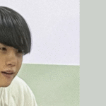 Scene from the Severance Hospital documentary featured in Bangtan Now about the Min Yoongi Treatment Center, showing Yoongi with dark straight hair and a light shirt, seated indoors. On the right side, the article title reads: “Min Yoongi Treatment Center – The gesture that moved (not so) fans around the world.”