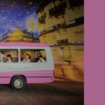 Promotional image for the album BTS Permission to Dance On Stage, published by Bangtan Now. In the photo, all seven BTS members are inside a white and pink van with the word “POLICE” written on the side. They're dressed in white outfits, radiating a light and joyful vibe, exchanging glances and smiles — some seated, others looking out the window, conveying a sense of friendship and ease. The background features a painted night scene, with a deep blue sky full of stars, golden-lit buildings, and warm reflections reminiscent of a nighttime city street. On the right side of the image, against a lilac background, is the title: “BTS Permission to Dance On Stage – The album that made 2025 dance (and feel)”, alongside the circular Bangtan Now logo in the upper corner.