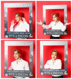 Jimin surge nas montagens natalinas da Dicon com um visual clássico e festivo, usando camisa branca impecável e gorro vermelho em contraste com o fundo vermelho vibrante e a moldura com neve e azevinhos onde se lê “Happy Holiday and a Happy New Year BTS x DICON”. Com expressões que variam entre sorrisos encantadores, braços abertos e olhares diretos que parecem dizer “presente de Natal? sou eu”, ele capricha na entrega visual e carismática, tornando cada clique digno de cartão comemorativo. Imagem especial do BTS Natal publicada no X do BTS e destacada no artigo do Bangtan Now.